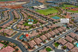 Aerial view of property and surrounding area with nearby suburban area