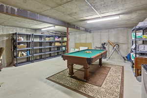 Recreation room featuring billiards table and unfinished concrete flooring