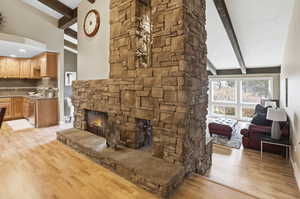 Living room with light wood-style flooring and a fireplace