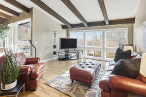 Living area with wood finished floors and healthy amount of natural light