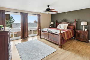 Primary bedroom featuring light wood finished floors and a ceiling fan