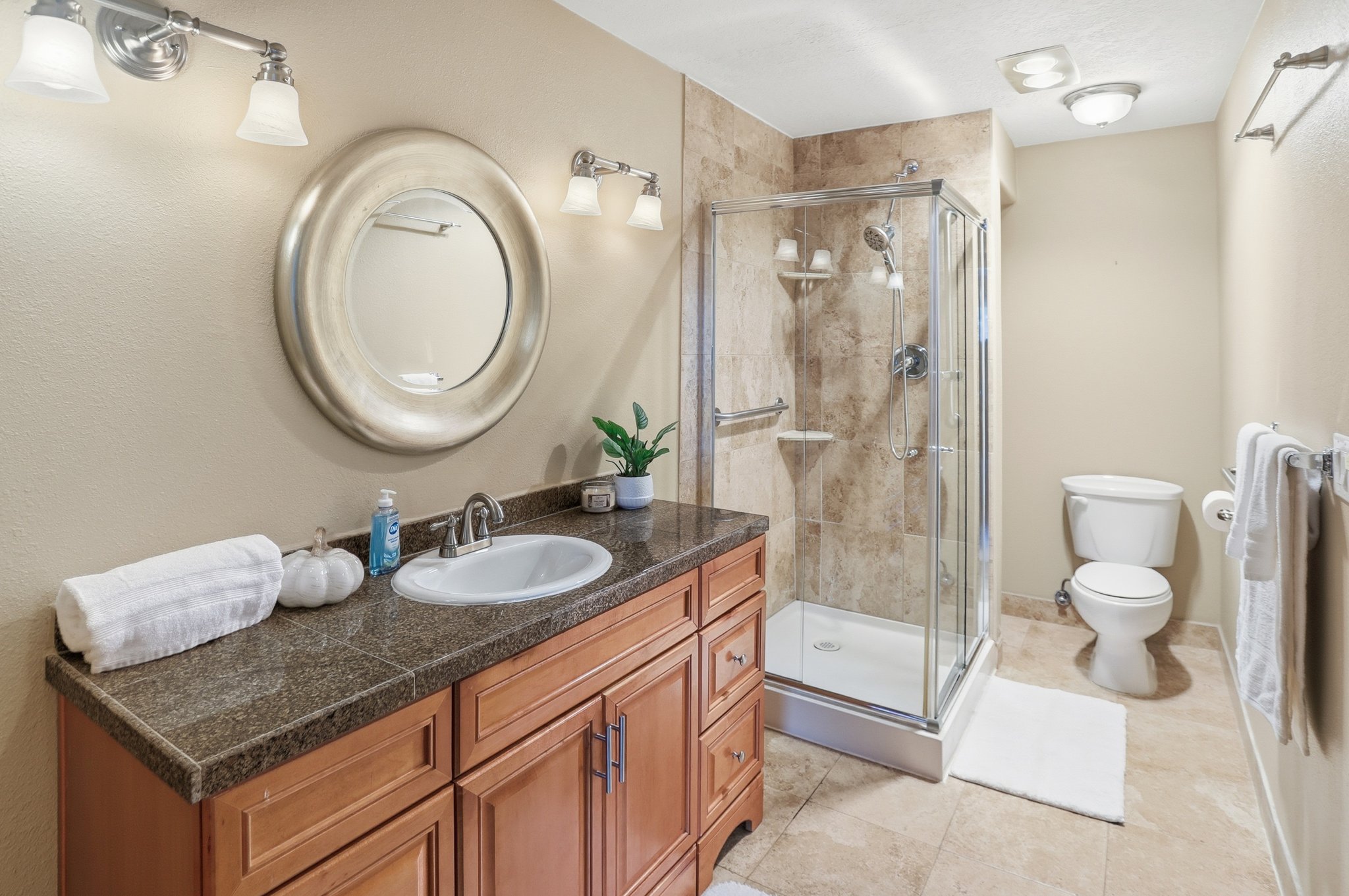 Primary Bathroom featuring vanity, a stall shower, and light tile patterned floors