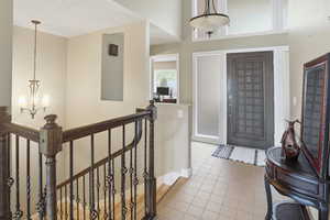 Entryway featuring a chandelier and light tile patterned flooring