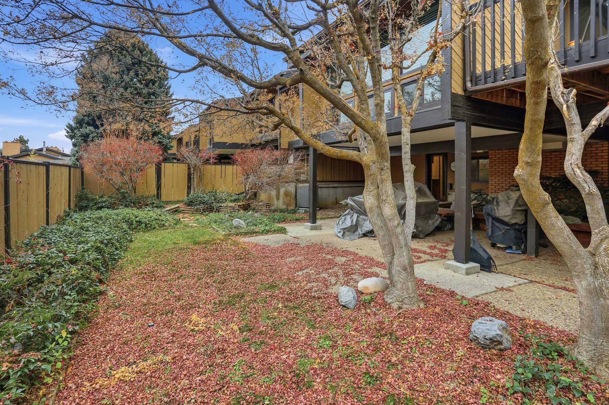 Fenced backyard with a patio