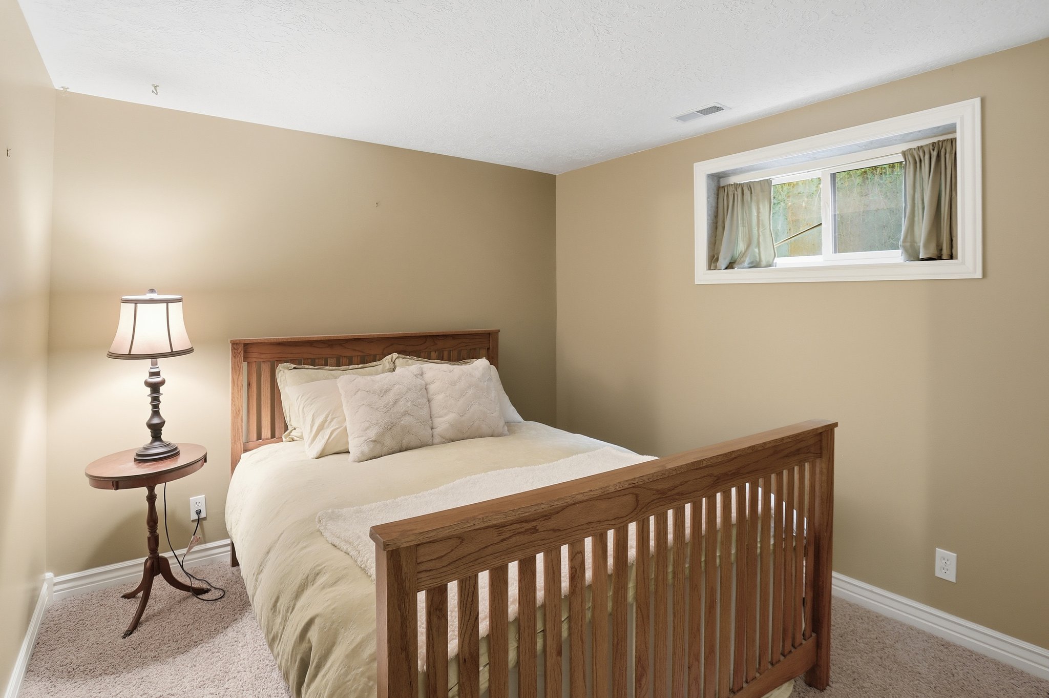 Carpeted bedroom featuring baseboards and a textured ceiling