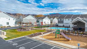View of home's community featuring a residential view, uncovered parking, and a swimming pool