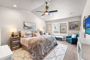 Bedroom with vaulted ceiling, light colored carpet, a ceiling fan, and recessed lighting