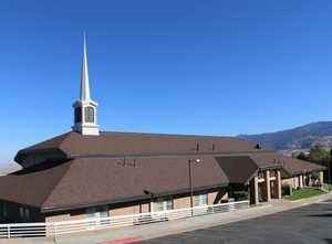 View of property featuring a mountain view and uncovered parking