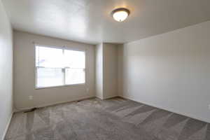 Carpeted spare room with baseboards