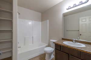 Bathroom featuring light tile patterned floors, vanity, and bathing tub / shower combination