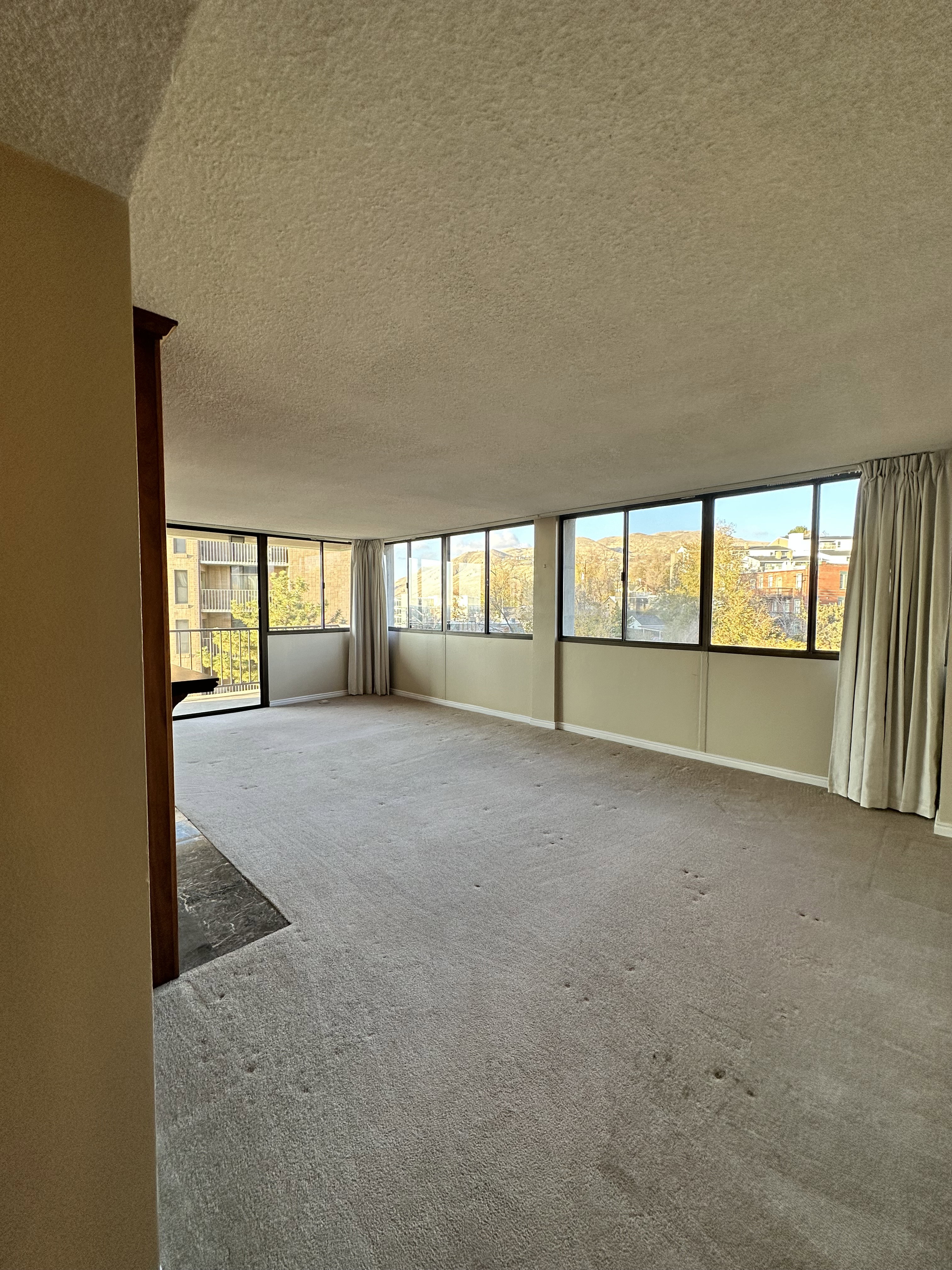 Unfurnished room featuring a textured ceiling and carpet