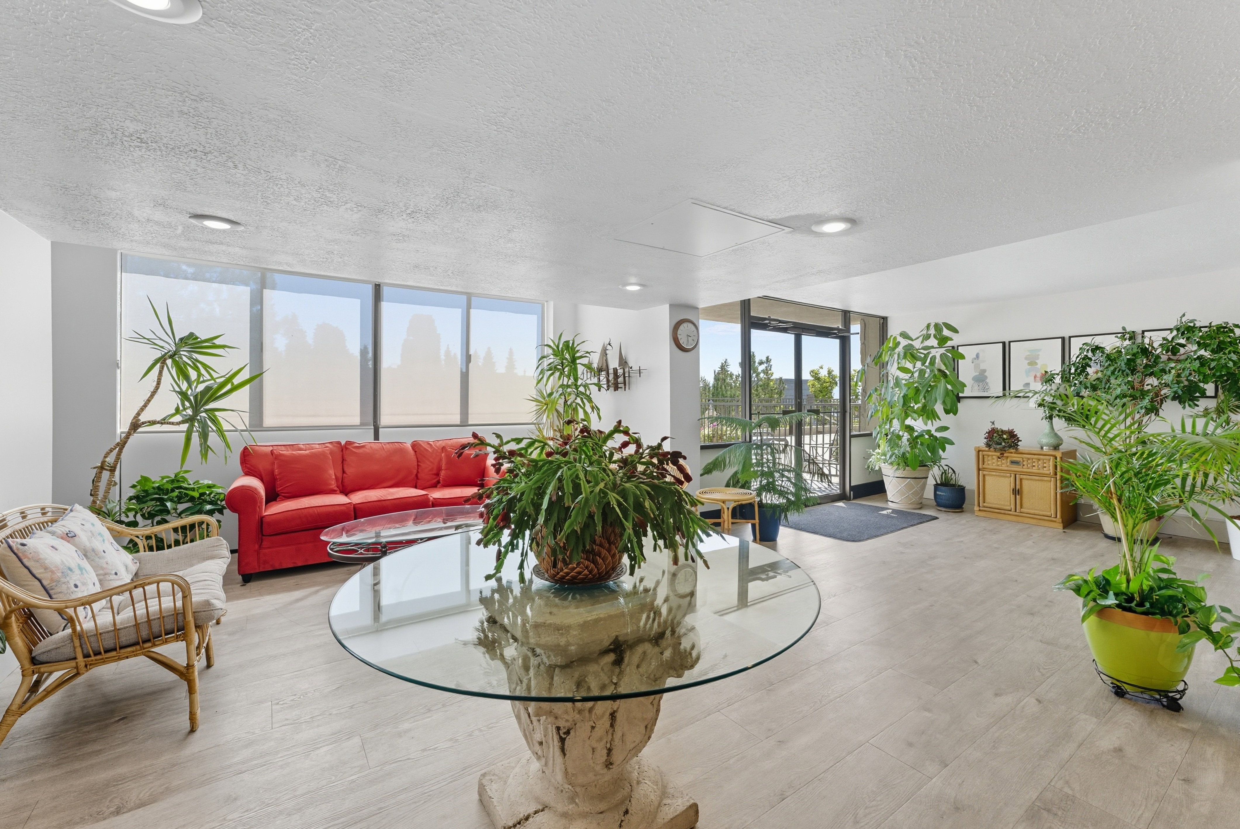 Living area featuring a wall of windows, a textured ceiling, and wood finished floors
