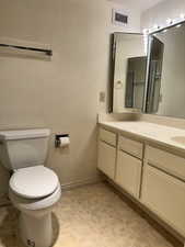 Bathroom with vanity and brick patterned floors
