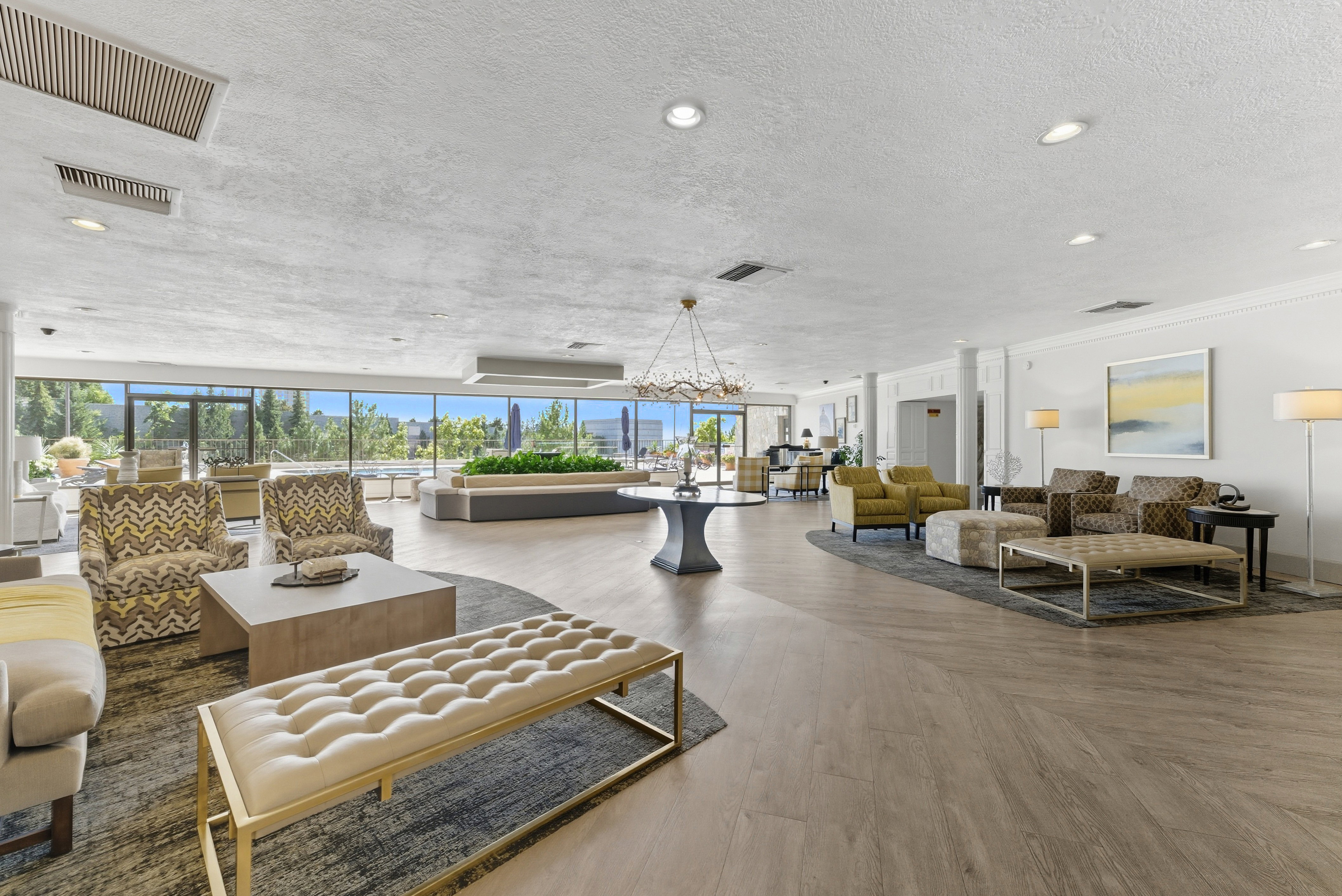 Lobby featuring a textured ceiling, recessed lighting, ornamental molding, and floor to ceiling windows