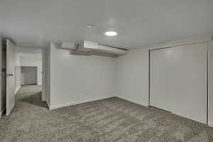 Bedroom with light carpet and a spacious closet