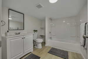 Large bathroom featuring vanity, shower / tub combination, shelfing and main  water shut off access