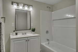 Bathroom featuring vanity and bathtub / shower combination