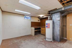 Basement featuring water heater and heating unit