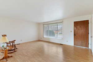 Unfurnished room with light wood-type flooring