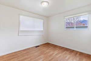 Spare room with light wood-style floors and baseboards