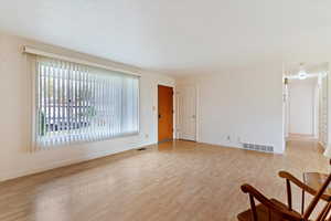 Empty room with light wood finished floors and baseboards