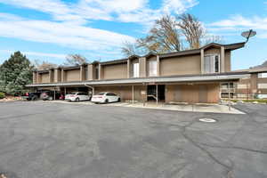 View of property with covered parking