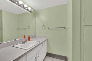 Bathroom featuring vanity and light tile patterned floors