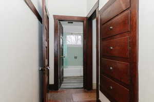 Hallway with dark wood finished floors