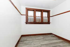 Empty room with baseboards and light wood-style flooring