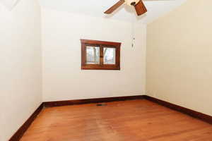 Unfurnished room with wood finished floors and ceiling fan