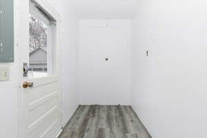 Doorway featuring wood finished floors and electric panel