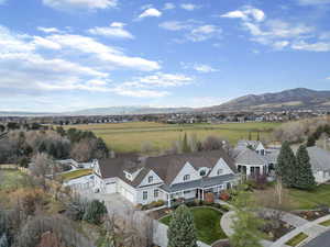 Overview of rural landscape featuring a mountainous background and nearby suburban area