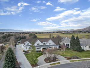 Aerial view of property and surrounding area featuring a mountain backdrop