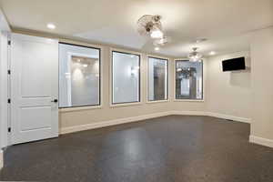 Spare room with baseboards and recessed lighting