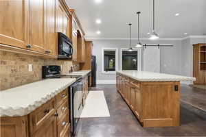 Kitchen with a barn door, brown cabinetry, finished concrete floors, black appliances, and light stone counters