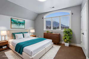 Bedroom featuring carpet, vaulted ceiling, and a closet