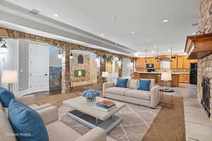 Living area with a large fireplace and recessed lighting