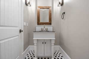 Half bathroom featuring vanity and baseboards