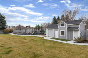 View of yard with an outdoor structure and a playground