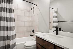 Full bathroom featuring vanity and shower / bath combo with shower curtain