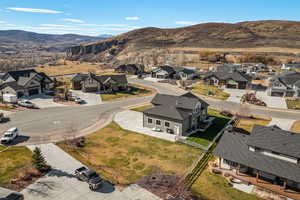 Aerial perspective of suburban area featuring a mountainous background