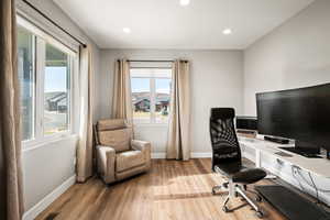 Office area featuring light wood-type flooring and recessed lighting