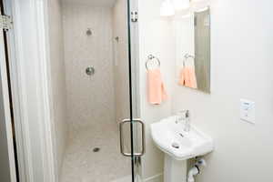 Executive Bathroom with floor to ceiling tile shower w/European style glass door.