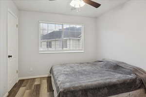 Bedroom with wood finished floors and ceiling fan