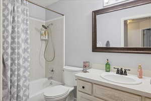 Bathroom featuring vanity and shower / bath combo with shower curtain