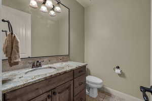 Bathroom with vanity and a chandelier