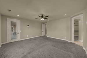 Spare room with recessed lighting, light carpet, arched walkways, and a ceiling fan