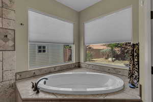 Full bathroom featuring a bath