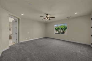 Empty room featuring light colored carpet, recessed lighting, and ceiling fan