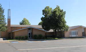 View of building exterior with uncovered parking